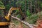 As part of the deforestation work, machinery is used to remove trees and lift logs in order to prepare land for future