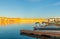 As sunsets light hits the rock embankments with a golden glow on other side Lake Powell a man-made reservoir on the Colorado River