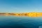 As sunsets light hits the rock embankments with a golden glow on other side Lake Powell a man-made reservoir on the Colorado River