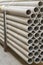 asbestos pipes in a stack in a warehouse or in a building store. Pallets with sewer pipes