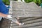 Asbestos removal roofer roof works. House with old, danger asbestos roof tiles repair and renovation.  Risks of Asbestos Roofs,