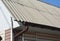 Asbestos roof with plastic rain gutter. Asbestos rooftop