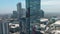 ascending aerial footage of the glass JW Marriott Hotel, with skyscrapers and office building in the city skyline