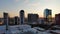 ascending aerial footage of the High Museum of Art, skyscrapers, hotels and office buildings in the city skyline at sunset