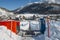 Ascending conveyor belt to a beginners run for children and parents in ski resort with mountains in background