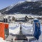 Ascending conveyor belt to a beginners run for children and parents in ski resort with mountains in background