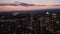 Ascending footage of cityscape at dusk. Evening aerial panoramic view of downtown with tall skyscrapers. London, UK