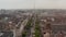 Ascending footage of wide boulevard with tree alley leading through urban neighbourhood. Tall monument, The spire