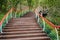 Ascending mountainside planked stairway with colorful railings