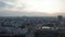 Ascending panoramic aerial footage of large town at dusk. Traffic on long straight street. Berlin, Germany