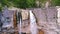 Ascending shot of two streams of the waterfall, aerial