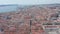 Ascending wide panoramic aerial reveal of Lisbon cityscape with densely packed traditional colorful houses with red