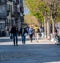 Ascona, Switzerland - April 15, 2019: People walking with biker leather fashion and biker helmets through the sunny city