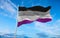 Asexual Pride flag waving in the wind at cloudy sky. Freedom and love concept. Pride month. activism, community and freedom