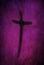 Ash cross drawn with finger on purple lenten backdrop