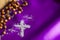 Ash Wednesday religion concept on violet fabric background with rosary