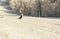 ASHA, RUSSIA - 27 april 2011: snowboarder descends on snow-covered slope and makes a turning maneuver, face is not visible,