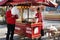 ASHGABAT, TURKMENISTAN - CIRCA DECEMBER 2014: Unidentified vendor prepares candy cotton and unidentified costumers. Ashgabat is t