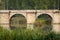 Ashlar stone medieval bridge, puente mayor, crossing rio carrion, in autumn. Palencia, Spain