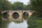 Ashlar stone medieval bridge, puente mayor, crossing rio carrion, in autumn. Palencia, Spain