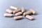 Ashwagandha Withania somnifera tablets and capsules on paper background.