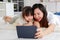 Asia black hair little cute girl and young beautiful mother lay down together smiling on white fluffy soft carpet floor watching