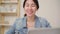 Asia business woman feeling happy smiling and looking to camera while relax at home office. Young asian woman working using laptop