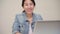 Asia business woman feeling happy smiling and looking to camera while relax at home office. Young asian woman working using laptop