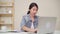 Asia business woman feeling happy smiling and looking to camera while relax at home office. Young asian woman working using laptop