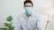 Asia businessman wear face mask social distancing in situation for virus prevention looking at camera smiling under surgical mask