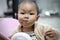 Asia Chinese little boy toddler child sit on child dinning-table board eat food with hands messy dirt on face