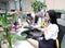 Asia Chinese office lady woman girl on chair make a call use desk phone chat work smile wear business occupation suit workplace