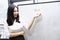 Asia Chinese office lady woman girl hand write success at whiteboard work smile wear business occupation suit workplace