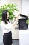 Asia Chinese office lady woman girl printing material use printer at work smile wear business occupation suit workplace