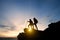 Asia couple hiking help each other silhouette in mountains with sunlight. couple hiking help each other silhouette in mountains