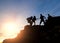 Asia couple hiking help each other silhouette in mountains with sunlight, Couple hiking help each other silhouette in mountains wi