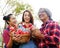 Asia family lover smile portrait and holding red apple in garden park.