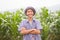 Asia farmer standing in middle corn fields and smiling face