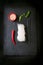 Asia food - rice noodles, spicy pepper, sticks and sesam, ready to cook on a dark stone background