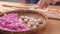 An Asia girl is making Tang yuan, yuan xiao, Chinese traditional food rice dumplings in red and white for lunar new year, winter f