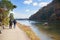 Asia, Japan. Kyoto, Sagano, Arashiyama, couple walking next to river,