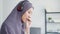 Asia muslim lady wear headphone watch webinar listen online course communicate by conference video call at house.