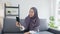 Asia muslim lady wear hijab using phone video call talking with couple at home. Young teenager making vlog video to social media