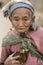 Asia, old woman with chicken