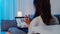 Asia student exchange female using laptop video call talking with family while working from home at living room at night. Self-