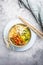 Asia style ramen soup with udon noodles, cabbage, bamboo sprouts and spicy pork