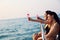 Asia two young woman smile portrait traveling and drinking wine on speed boat in summer for relaxation at Thailand.