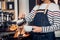 Asia woman barista pour milk into hot coffee cup at counter bar