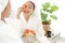 Asia women friends relaxing enjoy and spa massage with facial masks tomato put on bathrobe