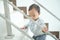 Asian 10 months old toddler baby girl child climbing up stairs at home alone, Movement, Stair climbing developmental milestone